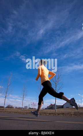 Young adult woman running outdoors in the city Stock Photo