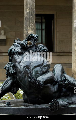Berlin German statue of a man fighting a lion outside Neues museum Stock Photo