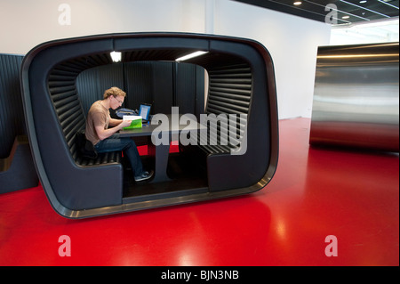 Student using modern study booth inside building on campus of Utrecht University in The Netherlands Stock Photo