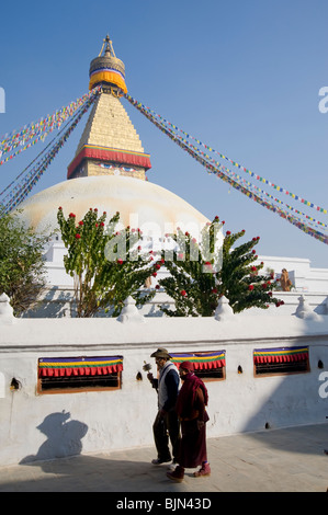 Buddhist pilgrims walking around the Boudhanath stupa in Kathmandu, Nepal Stock Photo