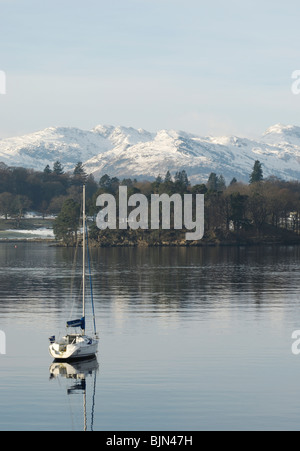 Yachts at Waterhead on Lake Windermere in the English Lake District with snow on the Langdale Pikes in the background. Stock Photo