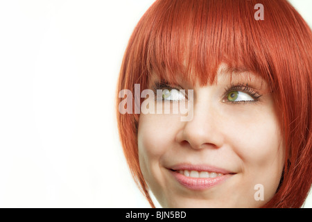 Face of young redhead woman having an idea Stock Photo