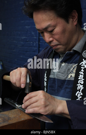 Mr Ohe engraving a Kikuichi knife Stock Photo