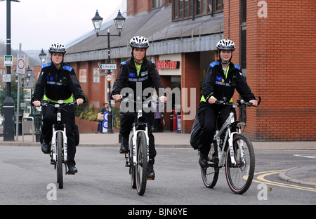 Three Police Community Support Officers patrolling on mountain bikes in Halesowen England Uk Stock Photo