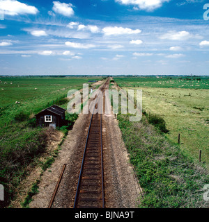 Railway tracks going into infinity over a flat landscape Stock Photo