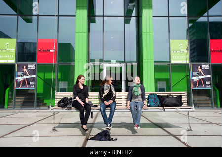 Students sitting in front of modern building on campus at Utrecht University in The Netherlands Stock Photo