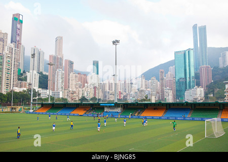 A football game being played on a pitch inside The Happy Valley Racing Course, Hong Kong Stock Photo