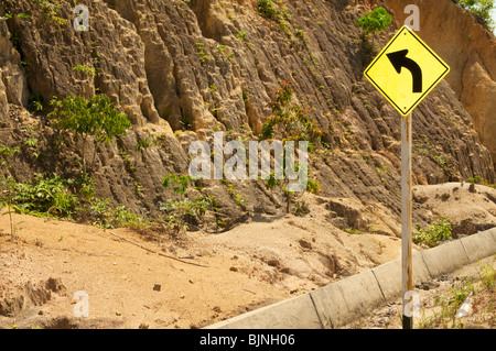 Left turn sign post on the mountain road to thong nai pan koh phangan Thailand Stock Photo