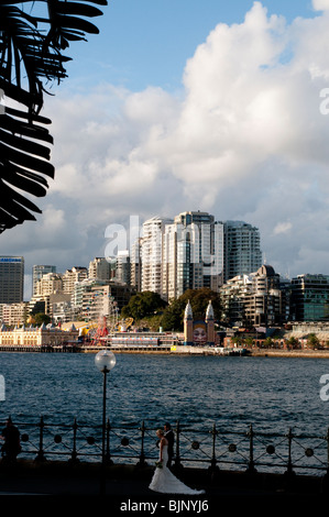 Luna Park at Milsons Point with bride and groom in the foreground, Sydney, Australia Stock Photo
