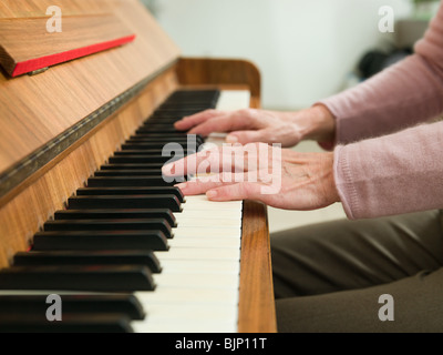 Senior woman playing the piano Stock Photo