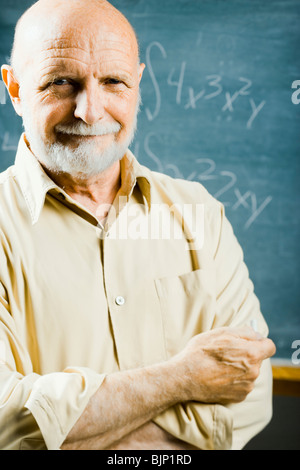 Closeup of male school teacher holding chalk Stock Photo