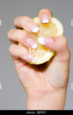 Woman squeezing a lemon Stock Photo