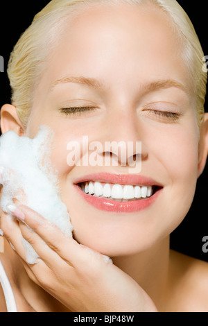 Woman washing her face Stock Photo