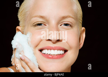 Woman washing her face Stock Photo