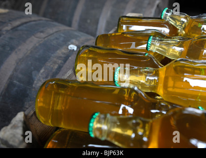 cider in bottles  on top of barrels Stock Photo