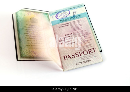 Open old, cancelled and new European Community, British  travel passports on white background, cut-out, United Kingdom Stock Photo