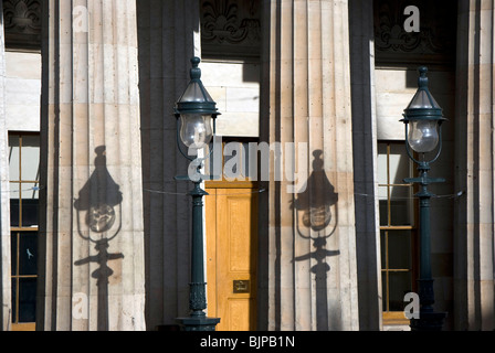 Old lamps and their shadows on the Royal Scotish Academy art gallery in Edinburgh. Stock Photo