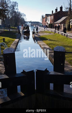 Narrowboat entering lock at Fradley Junction on the Trent and Mersey Canal near Lichfield, Staffordshire Stock Photo