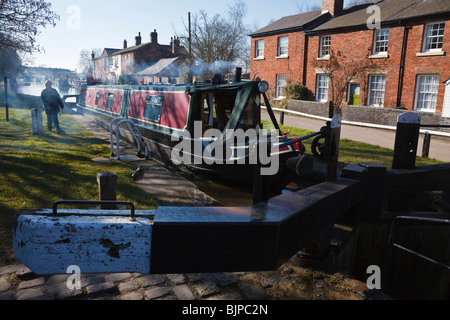 Narrowboat entering lock at Fradley Junction on the Trent and Mersey Canal near Lichfield, Staffordshire Stock Photo