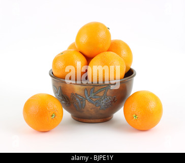 Naval oranges in vintage metal bowl on white background Stock Photo