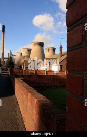 Giant cooling towers dominating the skyline and nearby houses. Ferrybridge power station,Ferrybridge, Yorkshire, UK Stock Photo