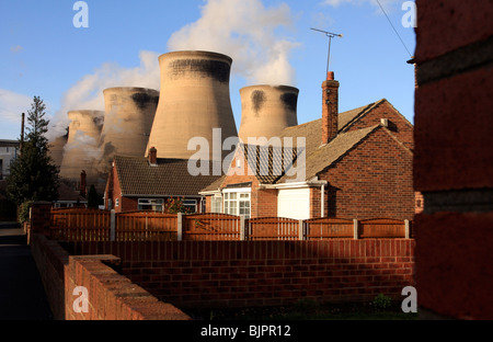 Giant cooling towers dominating the skyline and nearby houses. Ferrybridge power station,Ferrybridge, Yorkshire, UK Stock Photo