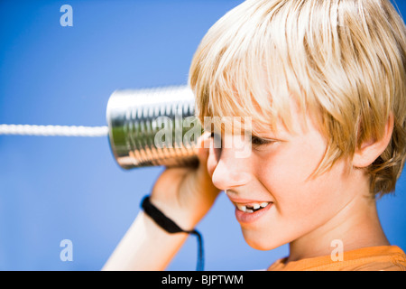 Boy with tin can phone Stock Photo