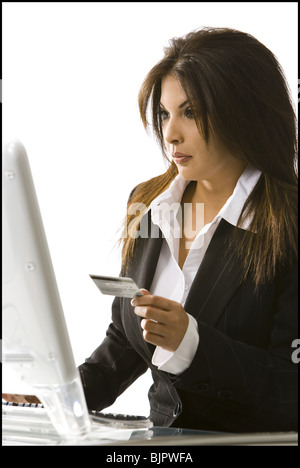 Woman using her credit  card on her computer Stock Photo