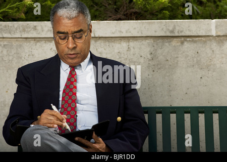 Businessman writing in his agenda Stock Photo