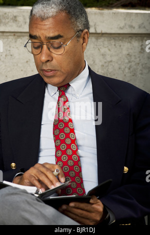 Businessman writing in his agenda Stock Photo