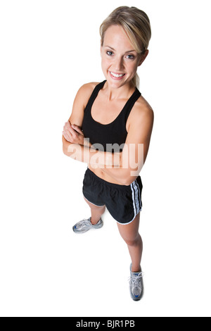 Woman standing with hands on hips Stock Photo