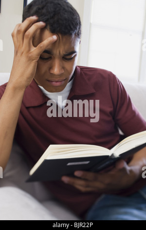 Teenage boy reading a book Stock Photo