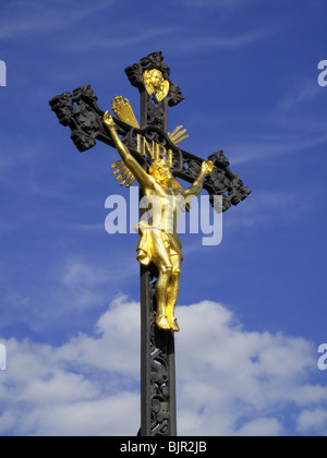 Gilded sculpture of Jesus Christ on iron cast crucifix Stock Photo