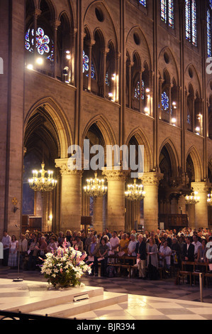 People pray inside Notre Dame de Paris, France Stock Photo