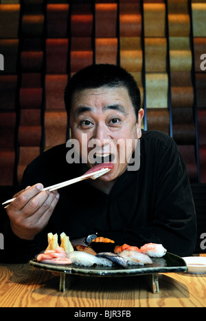 World-renowned Japanese chef Nobu Matsuhisa eats sushi at his restaurant in central Tokyo. Stock Photo