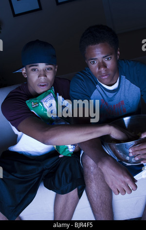 Two teenage boys eating snacks Stock Photo