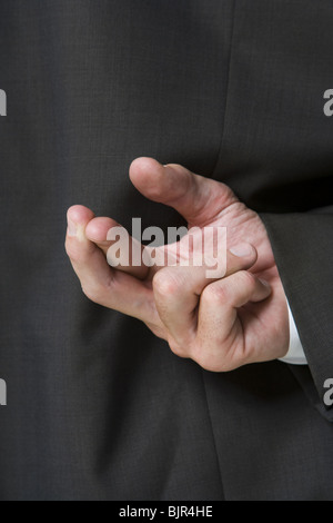 Fingers crossed behind businessman's back Stock Photo