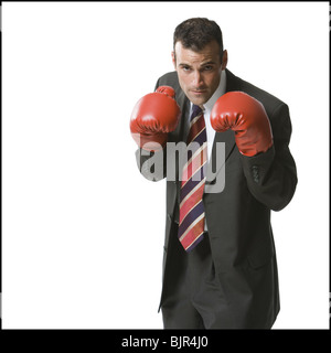 Businessman wearing boxing gloves Stock Photo