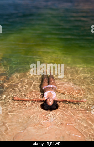 Woman lying in the water on back Stock Photo