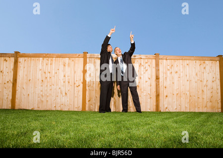 Two businessmen pointing at the sky Stock Photo