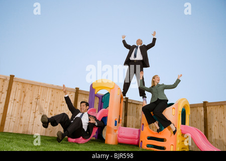 Three businesspeople playing on a jungle gym Stock Photo