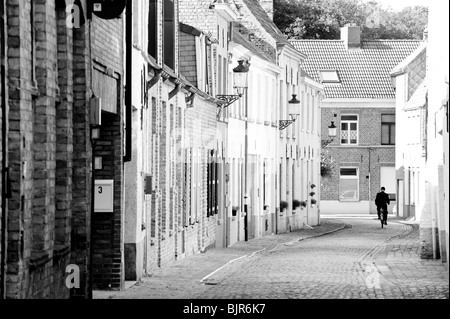 This is an image of a street in Brussels Belgium with a man cycling away. Stock Photo