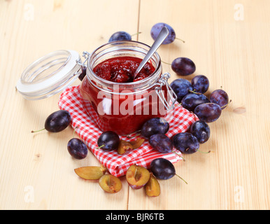 Jar of plum preserve and fresh plums Stock Photo