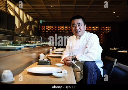 World-renowned Japanese chef Nobu Matsuhisa sits at the counter at his restaurant in central Tokyo, Japan. Stock Photo