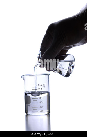 Lab technician wearing latex glove using poring liquid into flask Stock Photo