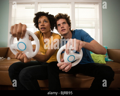 USA, Utah, Provo, young couple playing video games in living room