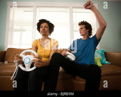 USA, Utah, Provo, young couple playing video games in living room Stock Photo
