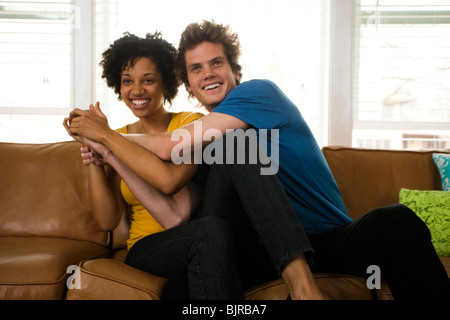 USA, Utah, Provo, young couple fighting over the TV remote