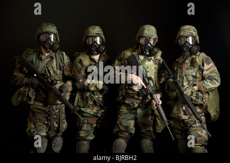 Two soldiers posing with gas masks Stock Photo