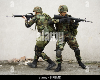 Soldiers aiming weapons Stock Photo